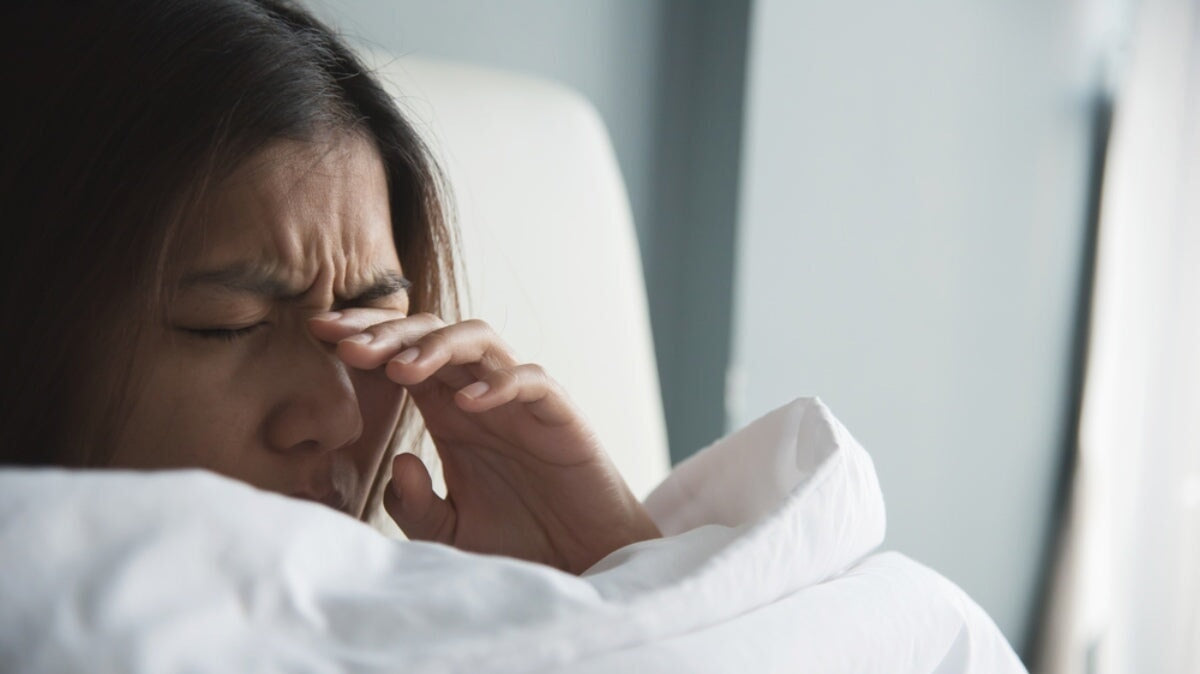 une fille fatiguée masse les yeux d'une vision floue